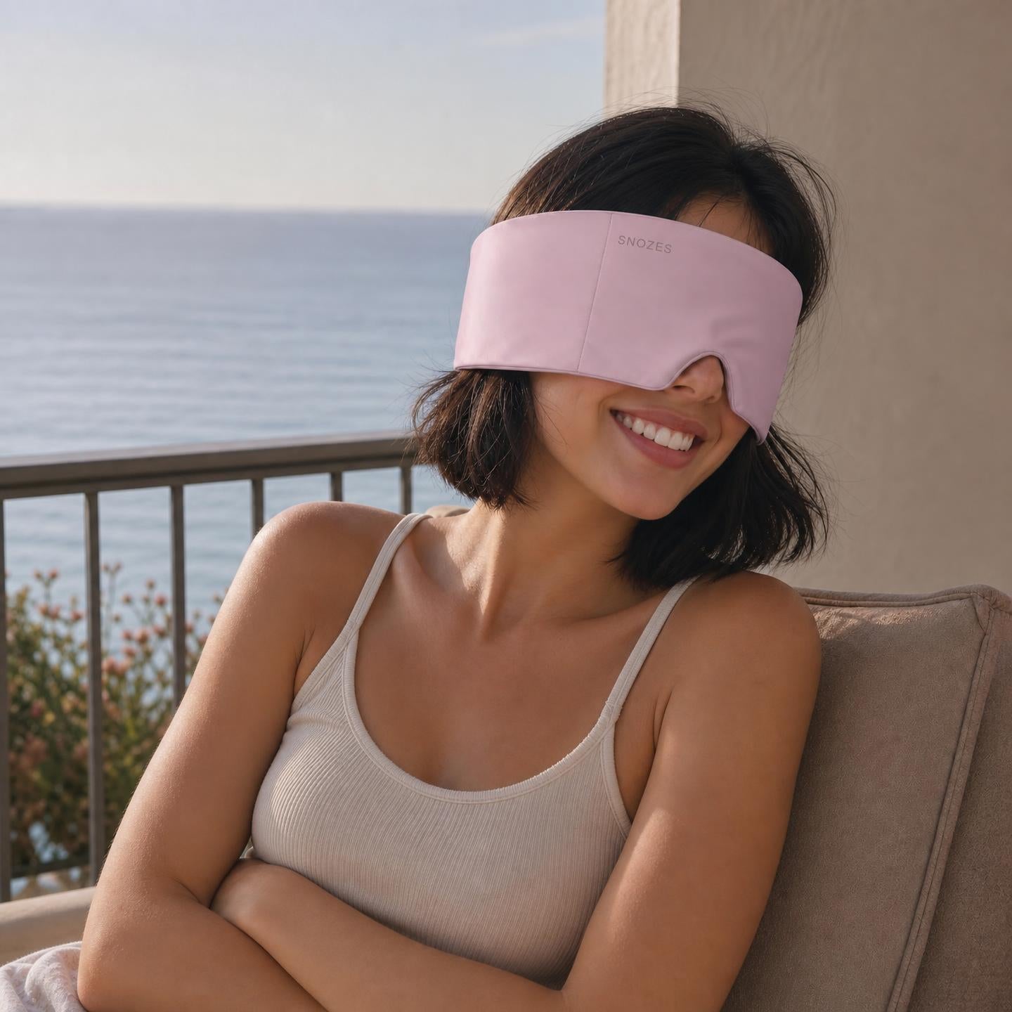Woman wearing the SNOZES mask, ready to fall asleep